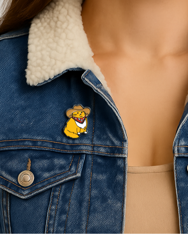 Person wearing a blue denim jacket with a white fur collar and a cartoon character pin.